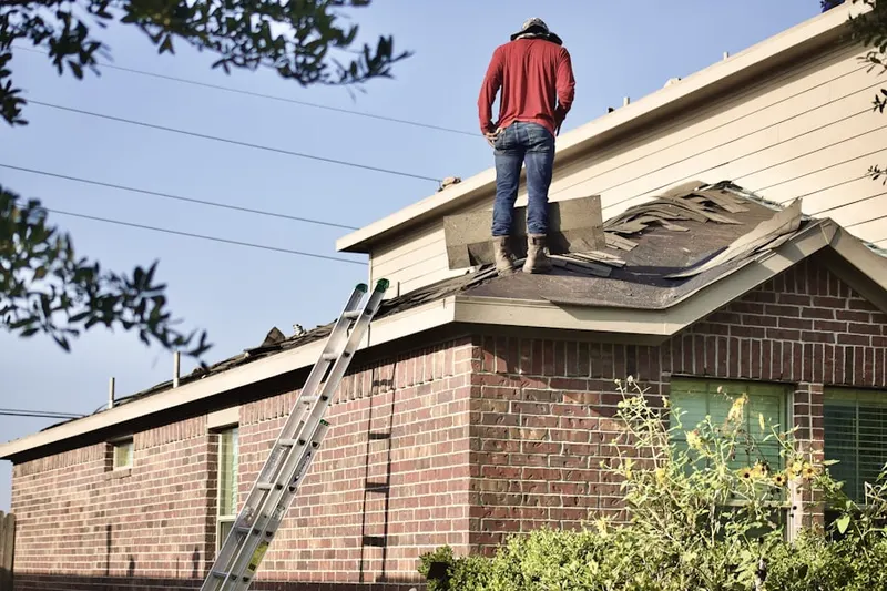 Professional roofer working on a residential roof in Downtown Lemont